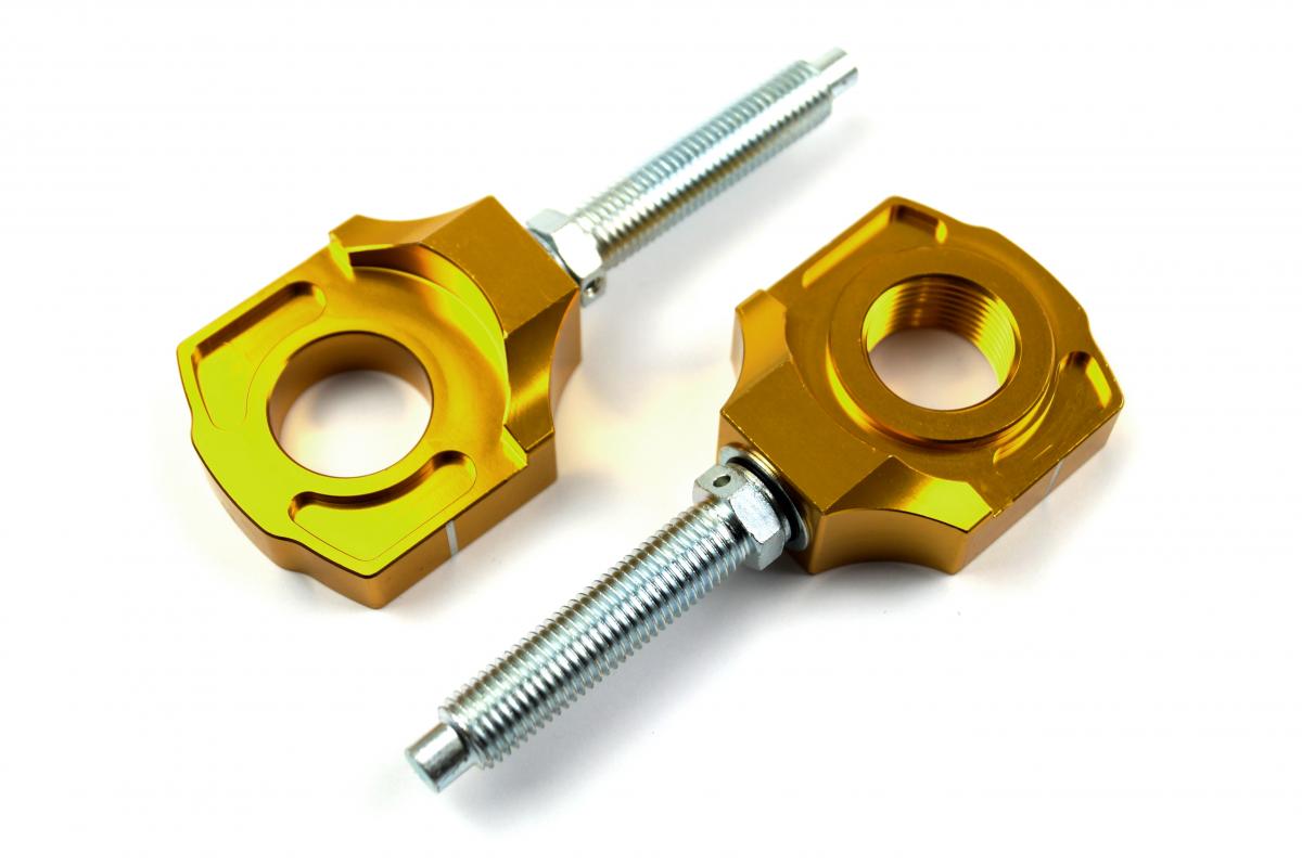 AXLE BLOCK & BOLT KTM GOLD image 1